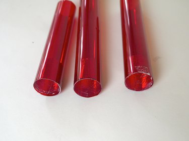 Three red tubes with foil in the ends.