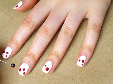 Two or Three Dots of Red Polish on Each Nail.