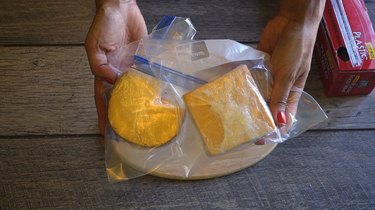 Preparing cheese for freezing.