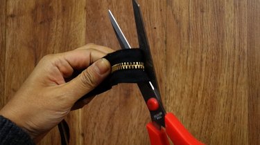 Cutting zipper to make a bracelet.