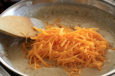 Grated cheese in the pan.