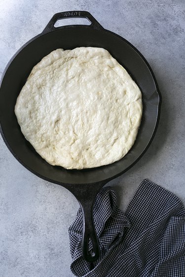 Pizza dough in cast iron skillet