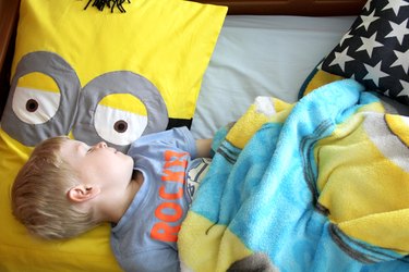 Child sleeping on minion pillow