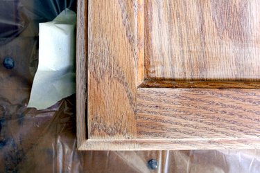 tape off hinges using painters tape | How to Paint Oak Bathroom Cabinets
