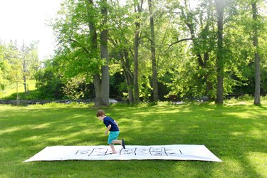 little boy playing hopscotch