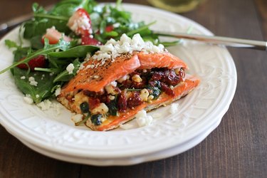 Salmon fillet stuffed with sun-dried tomatoes, spinach, basil, and feta cheese.