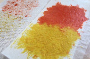 Orange and yellow crayon that has been melted under an iron, between wax paper sheets