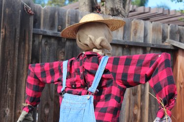 Chic straw hat added to scarecrow.