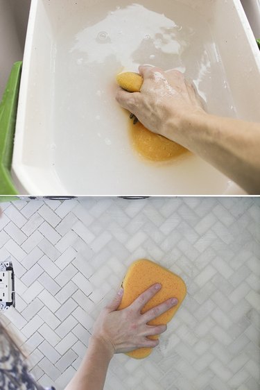 Removing excess grout with wet sponge.