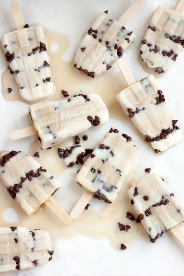 Melty group of many chocolate chip ice pops on marble