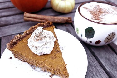 Piece of gluten-free low-carb pumpkin pie with almond meal crust.