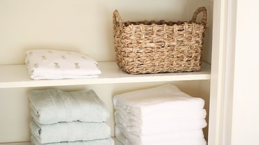 Organized linen closet with cleanly folded fitted sheet