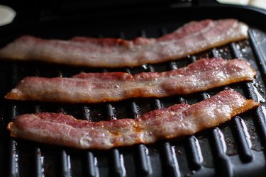 Cooked bacon on a grill.