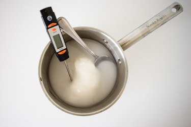 Sugar, water and lemon juice in a saucepan with a thermometer.