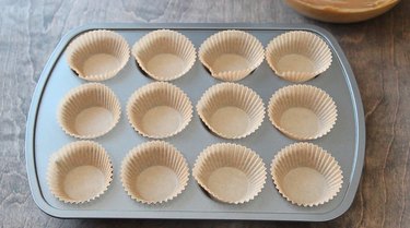 Muffin pan with paper liners in place.