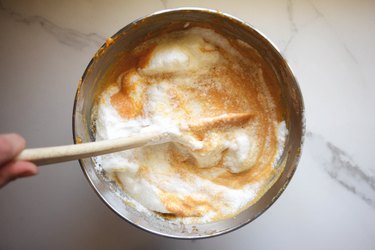 Fold the whisked egg whites gently into the cake batter.