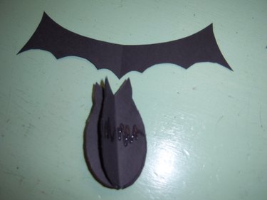 Puff the bat back up by bending the wings after attaching them.