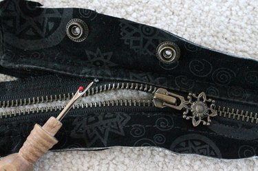 Use a seam ripper to remove zipper.