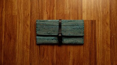 Upcycled no-sew clutch from a fabric placemat and faux leather belt