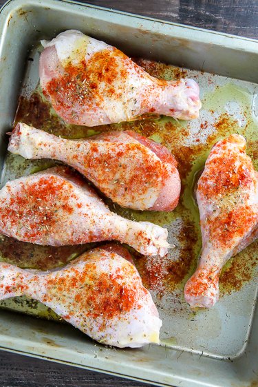 Drizzle drumsticks in olive oil and sprinkle with seasoning.