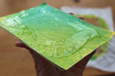 The melted crayon wax paper with glue on top of it, and glued to the acrylic frame