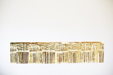 Gold fringe garland on wall