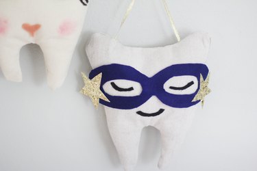 Superhero mask on tooth fairy pillow