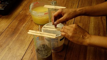 Placing candle wick on cement base for DIY candles with cement base project