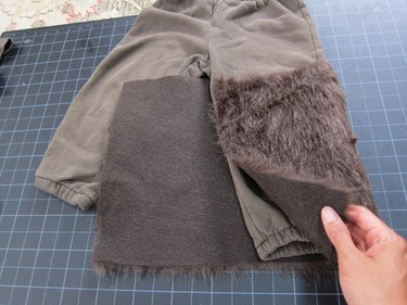 Wrapping each pants leg in fur.