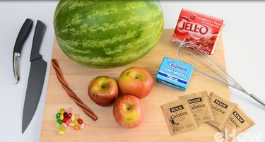 Photo of things you'll need: knives, watermelon, apples, gelatin and candy.