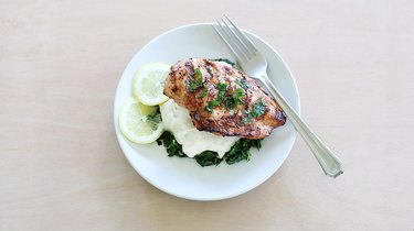Lemon herb chicken plated with mashed potatoes and spinach