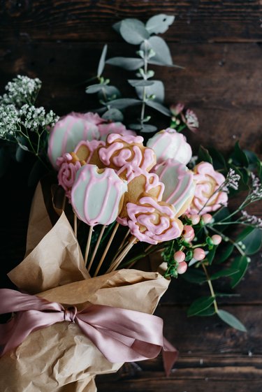 Turn the sugar cookies into bouquet form by adding fresh flowers, wrapping paper and ribbon!