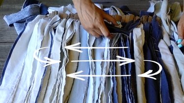 Weaving rag rug using a cardboard loom and fabric scraps.