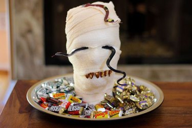 Shock party guests by serving them a mummy-head platter.