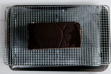 Place the cake onto a cooling rack set over a lined baking tray for no mess.