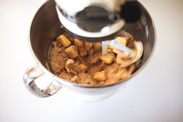 A mixer beating together the butter and sugars.