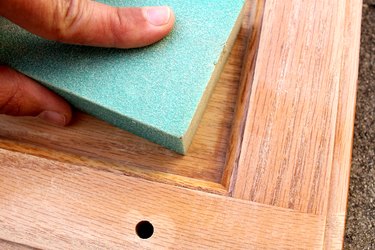hand sand crevices | How to Paint Oak Bathroom Cabinets