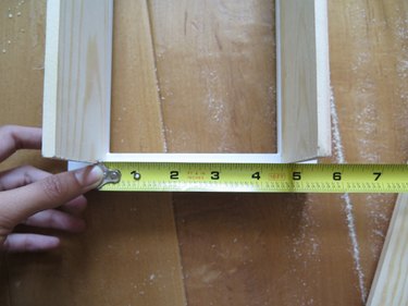 Measure the shortest side between the two long wood boards.