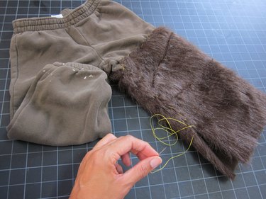 Sewing fur leg to itself.