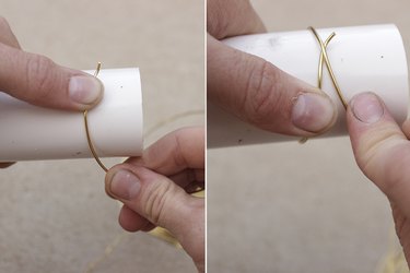 Wrapping PVC one time while holding down with thumb.