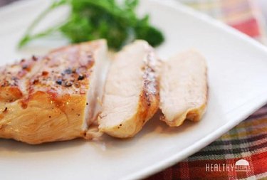 Grilled chicken breast, sliced on a plate.