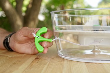 The salad spinner handle is shown outside the bowl