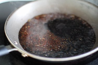 Balsamic vinegar simmering in a skillet