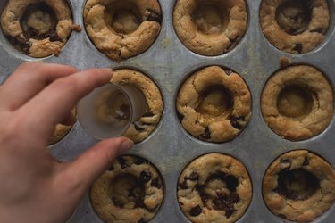 Use the back of a shot glass to form indents in the middle of the cookie cups.