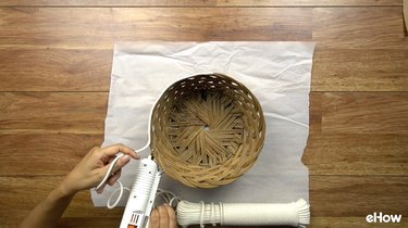 Gluing rope onto basket for DIY desert-style baskets.