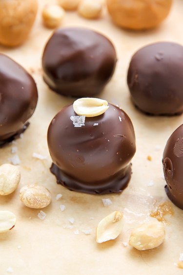 No-Bake Chocolate Peanut Butter Balls topped with sea salt and a peanut.