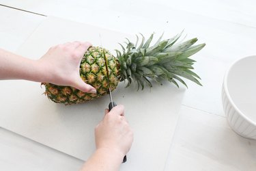 Cut off the top of the pineapple