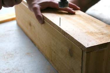Hammering nail into wood