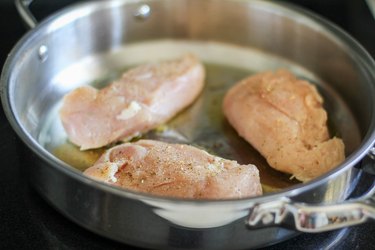 Chicken cooking in a skillet