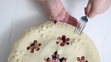 Crimping edge of pie with fork